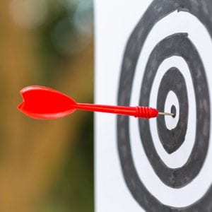 Dart in Bulls-eye of Target
