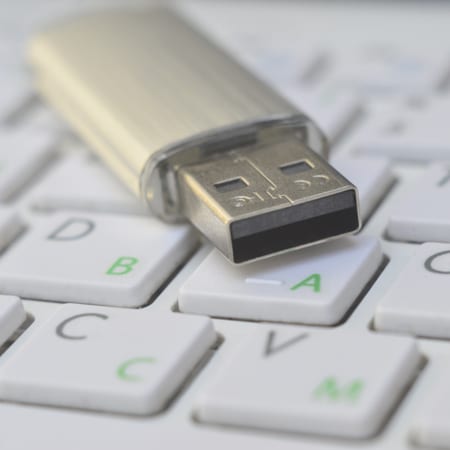 thumb drive on computer keyboard