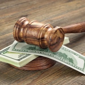 Stack Of Dollar Banknotes With Judges Or Auctioneers Gavel Or Hammer, Trial Or Tribunal Concept, Auction Concept, Close Up